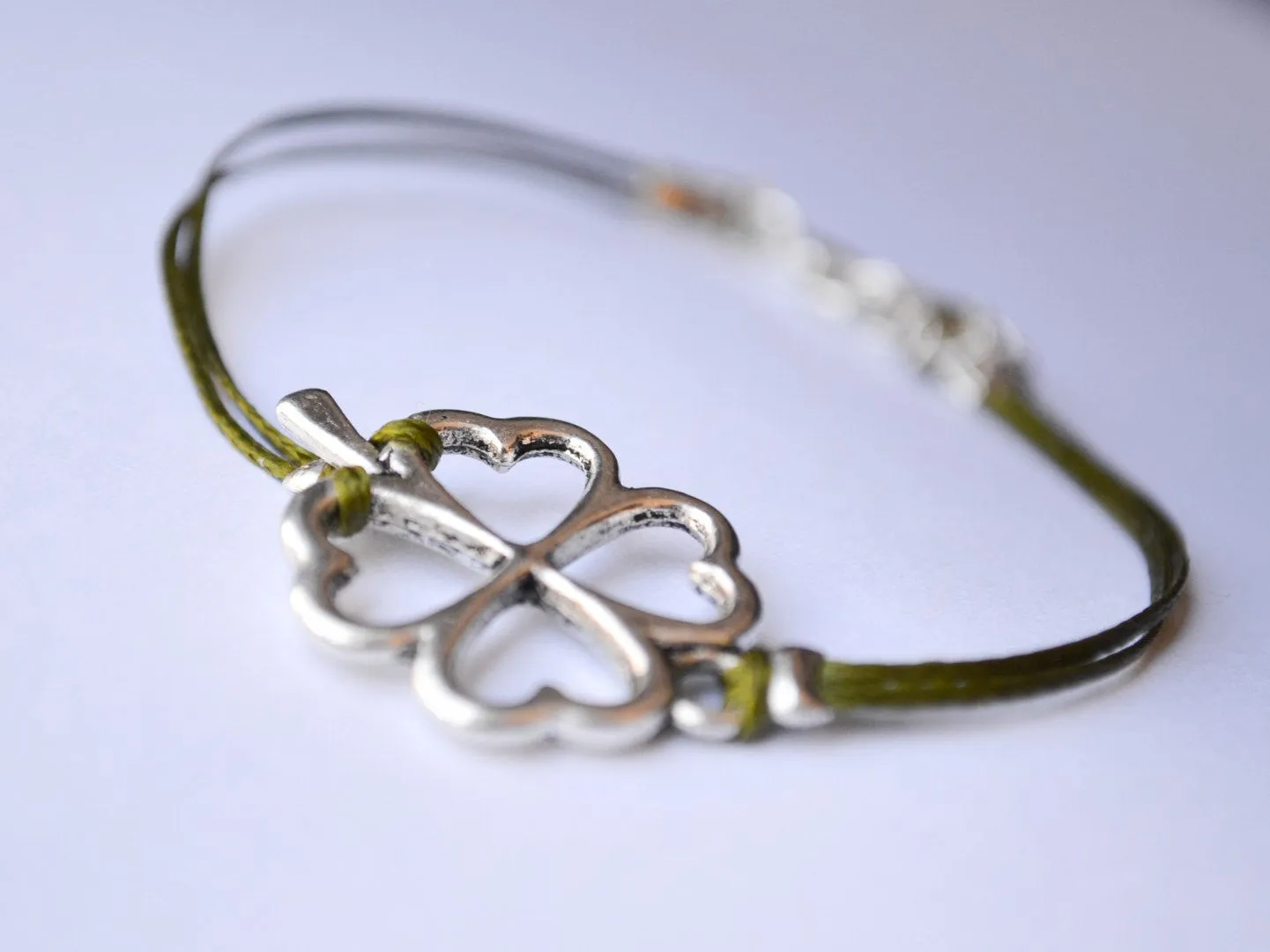 Silver tone clover charm bracelet green cord